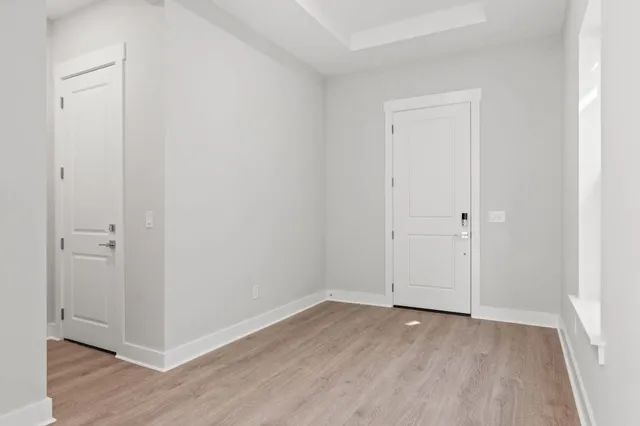a view of an empty room with wooden floor