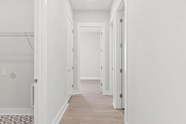 a view of a hallway with wooden floor