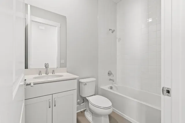 a bathroom with a sink toilet vanity and shower