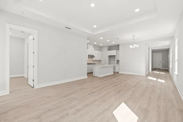 a view of large kitchen with a sink and a refrigerator