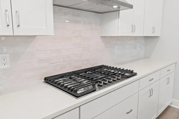 a close view of a stove a microwave and cabinets in the kitchen