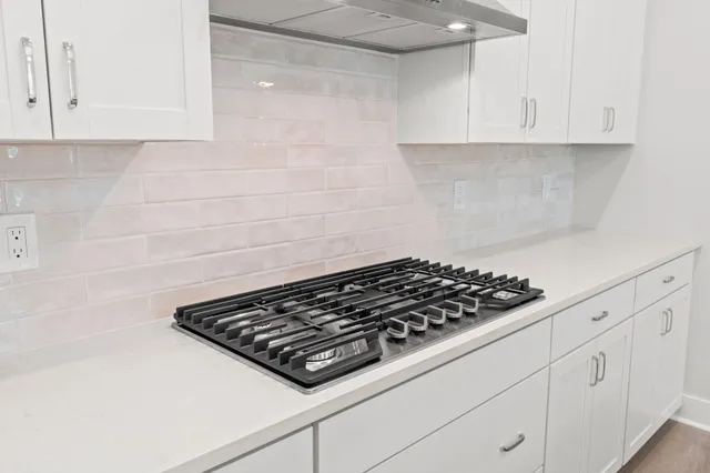 a close view of a stove a microwave and cabinets in the kitchen