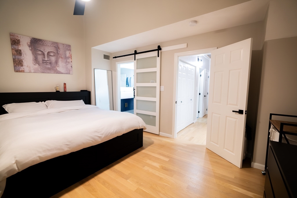 2 Turning Mill Lane, Unit 1 Quincy, MA 02169 - Photo 11 of 15 a bedroom with a bed and a walk in closet