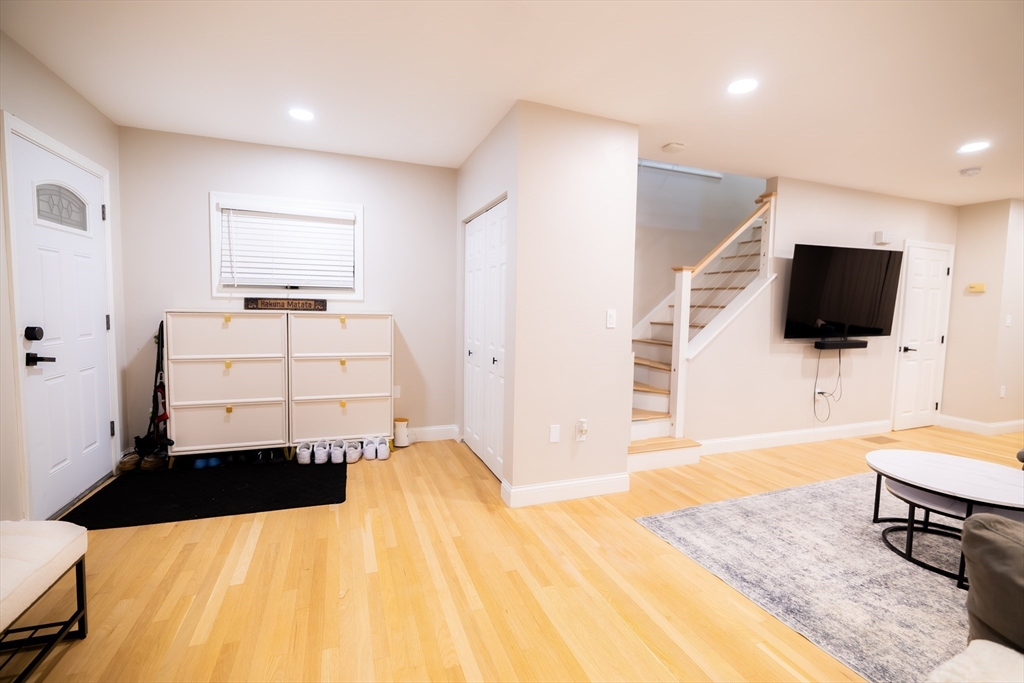 2 Turning Mill Lane, Unit 1 Quincy, MA 02169 - Photo 2 of 15 a room with a bed furniture and a flat screen tv