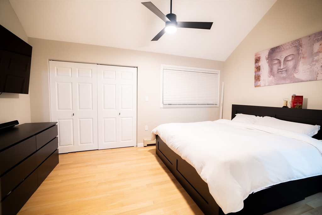 2 Turning Mill Lane, Unit 1 Quincy, MA 02169 - Photo 10 of 15 a spacious bedroom with a bed and a flat screen tv