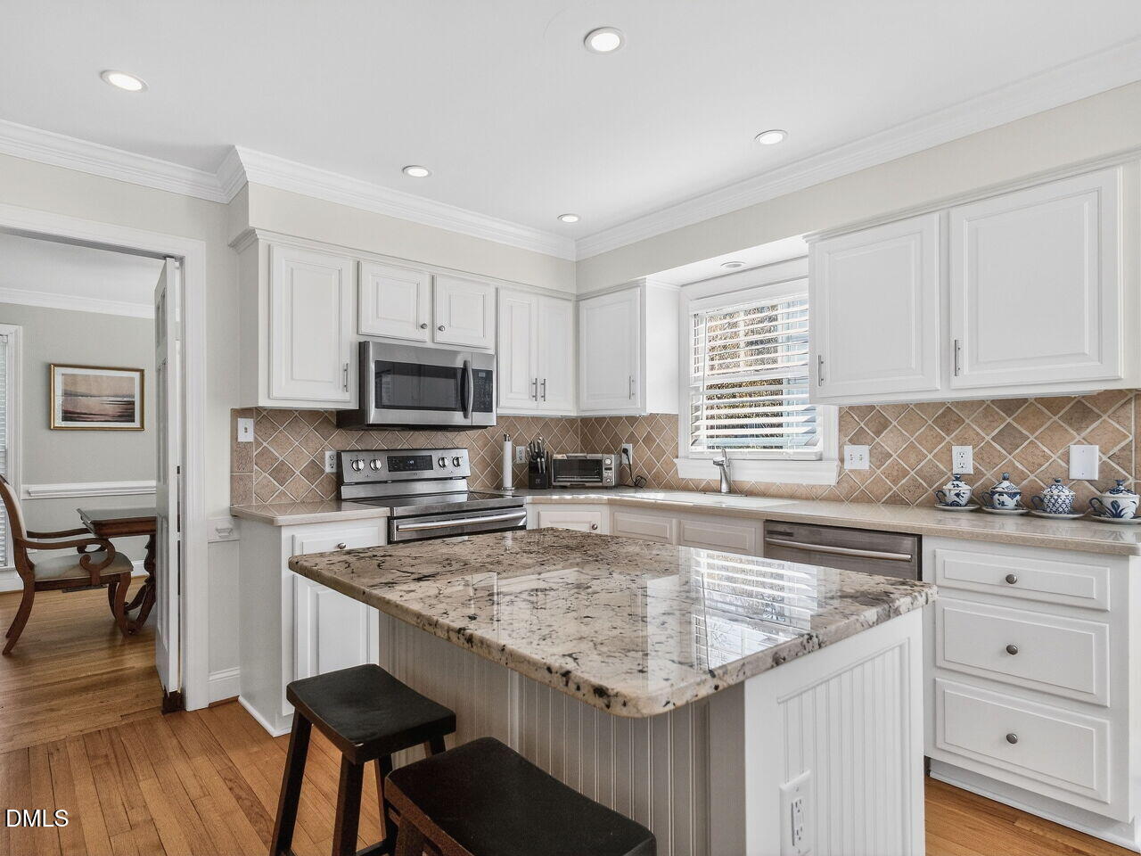 1917 Hamrick Drive Raleigh, NC 27615 - Photo 4 of 23 a kitchen with granite countertop a sink counter top space appliances and cabinets