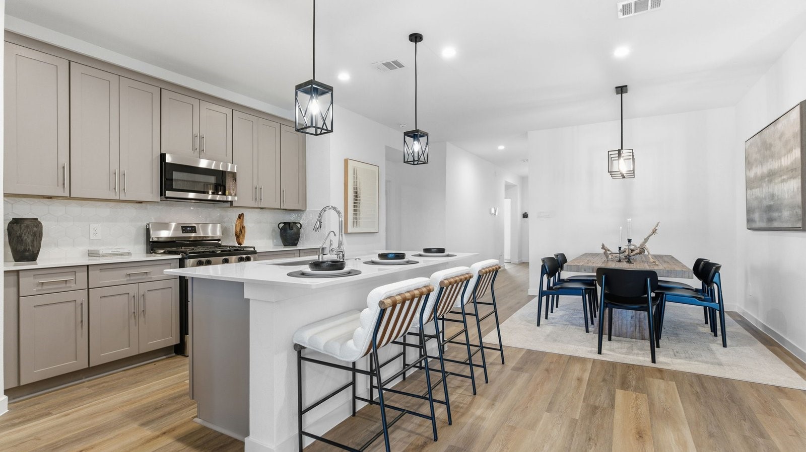 3229 Bolt Rope Drive Texas City, TX 77510 - Photo 2 of 20 a kitchen with stainless steel appliances granite countertop a stove a sink a kitchen island with a dining table and chairs