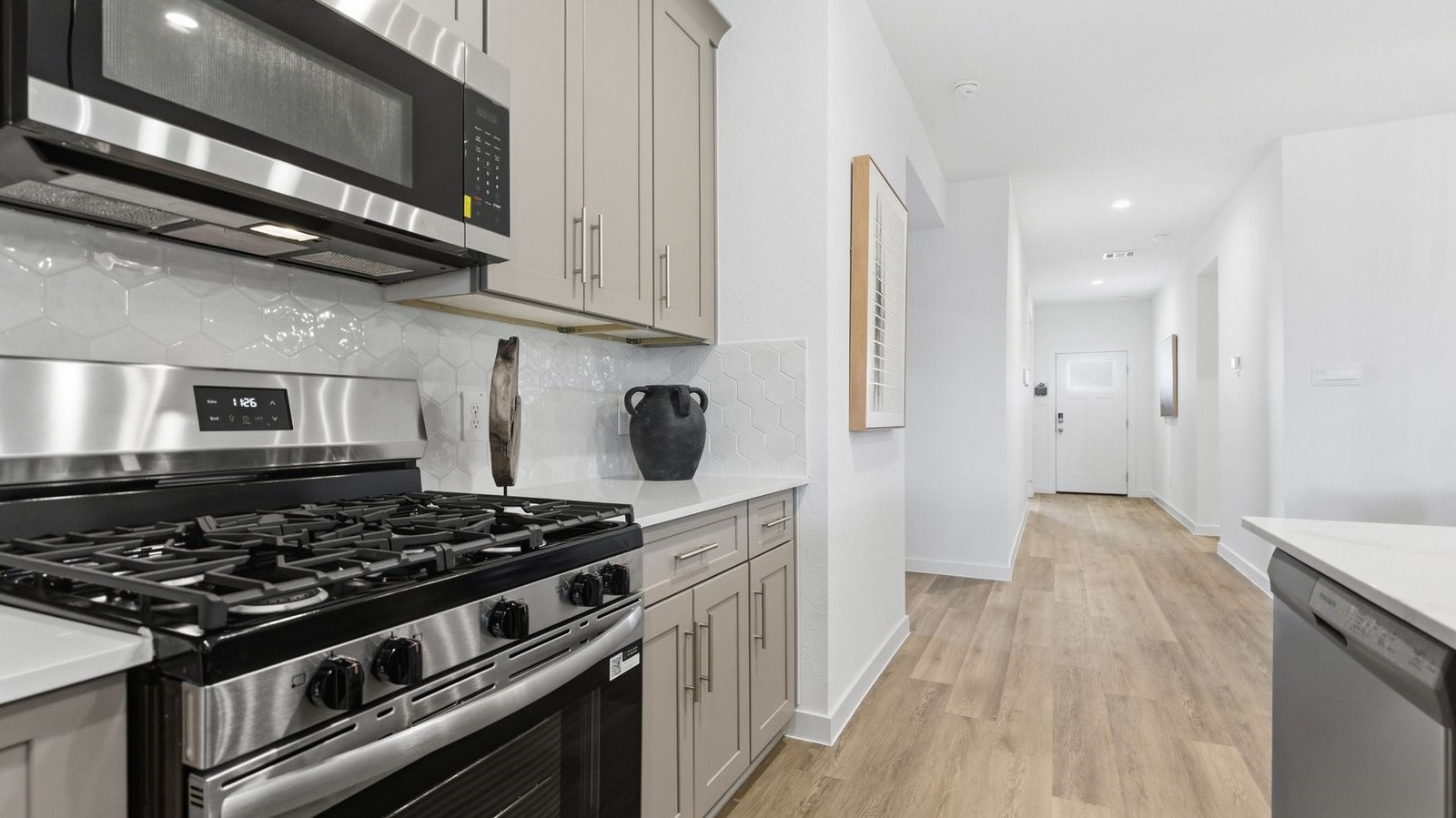 3229 Bolt Rope Drive Texas City, TX 77510 - Photo 3 of 20 a kitchen with stainless steel appliances granite countertop a stove and a microwave