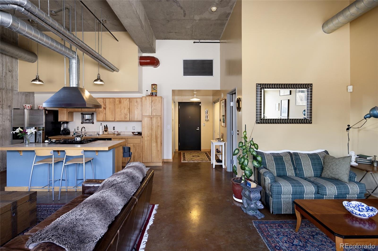 2000 Little Raven Street, Unit 102 Denver, CO 80202 - Photo 12 of 36 a living room with furniture and a wooden floor