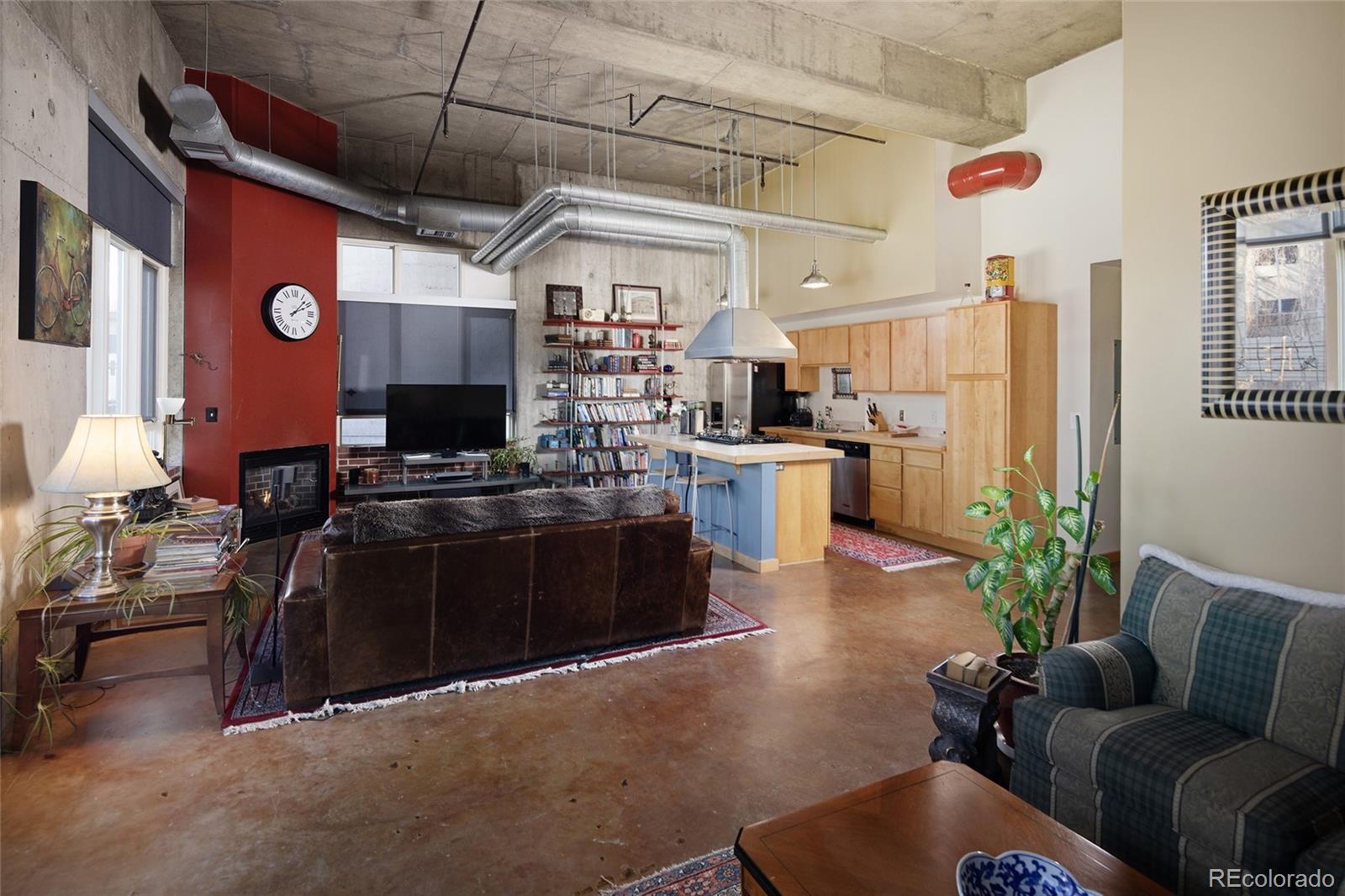 2000 Little Raven Street, Unit 102 Denver, CO 80202 - Photo 13 of 36 a living room with furniture and a flat screen tv