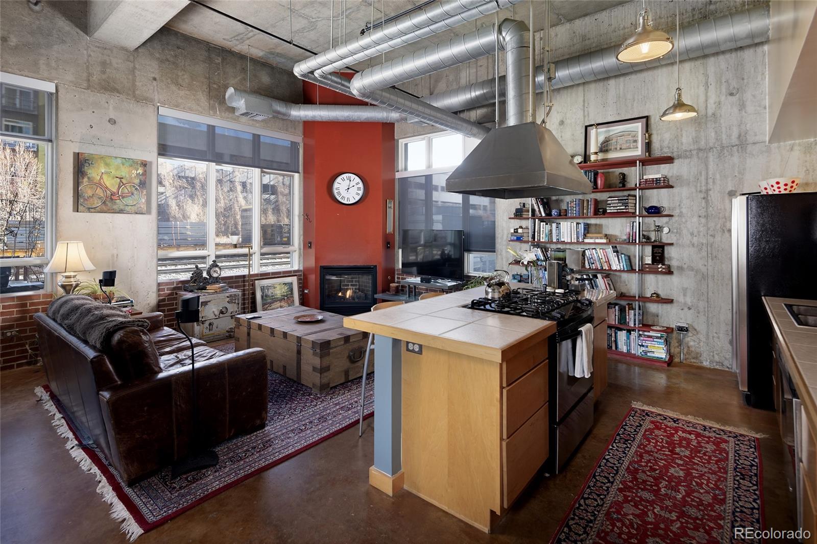 2000 Little Raven Street, Unit 102 Denver, CO 80202 - Photo 14 of 36 a open kitchen with stainless steel appliances granite countertop a stove and a refrigerator