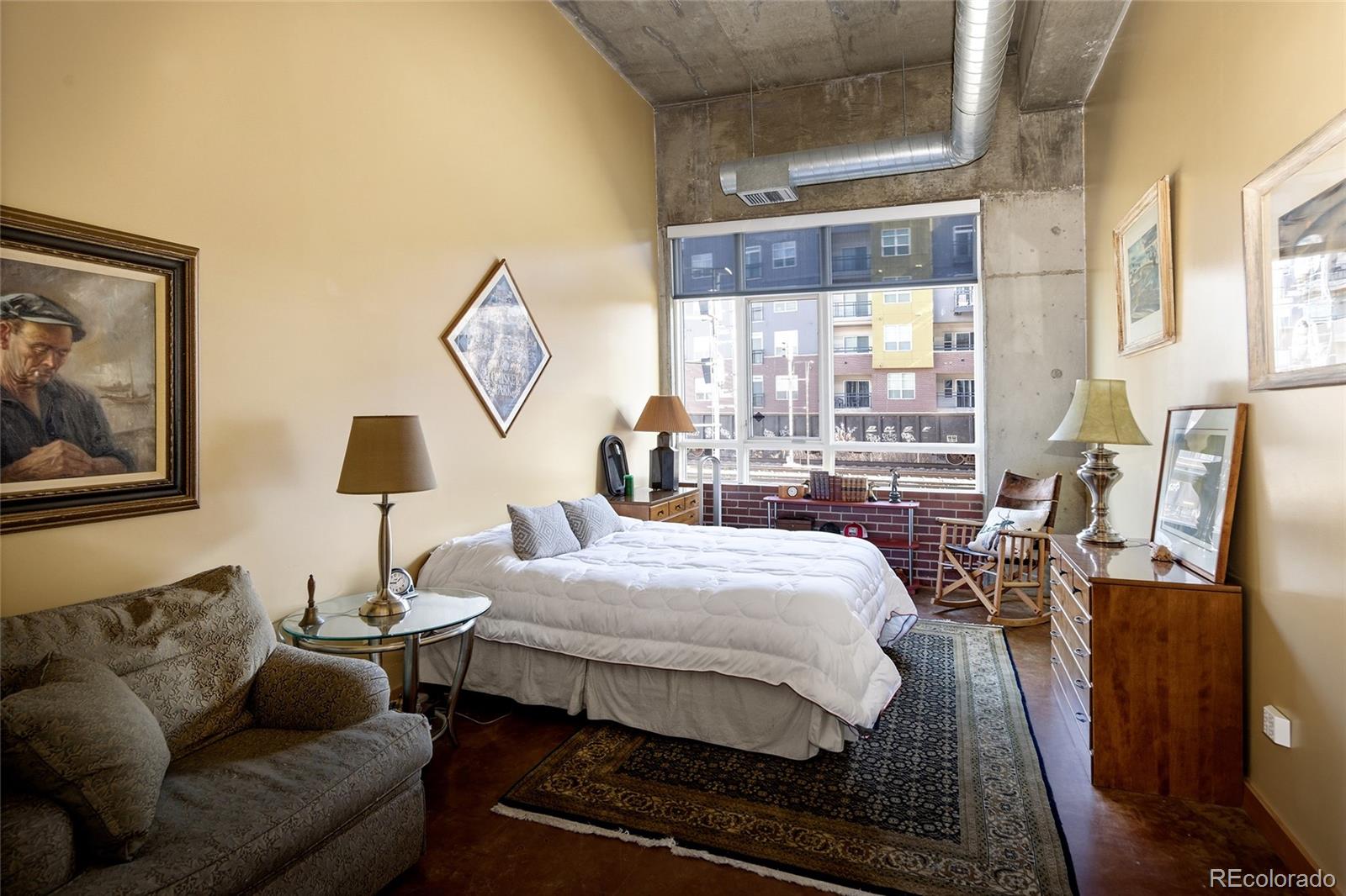 2000 Little Raven Street, Unit 102 Denver, CO 80202 - Photo 18 of 36 a bedroom with a bed and wooden floor