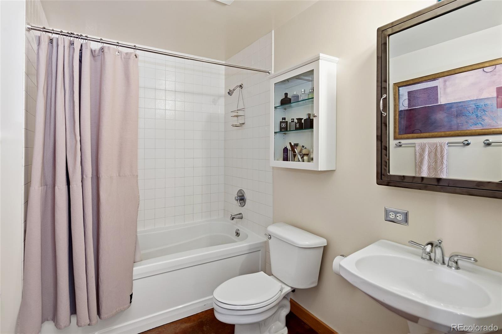 2000 Little Raven Street, Unit 102 Denver, CO 80202 - Photo 20 of 36 a bathroom with a sink toilet and shower