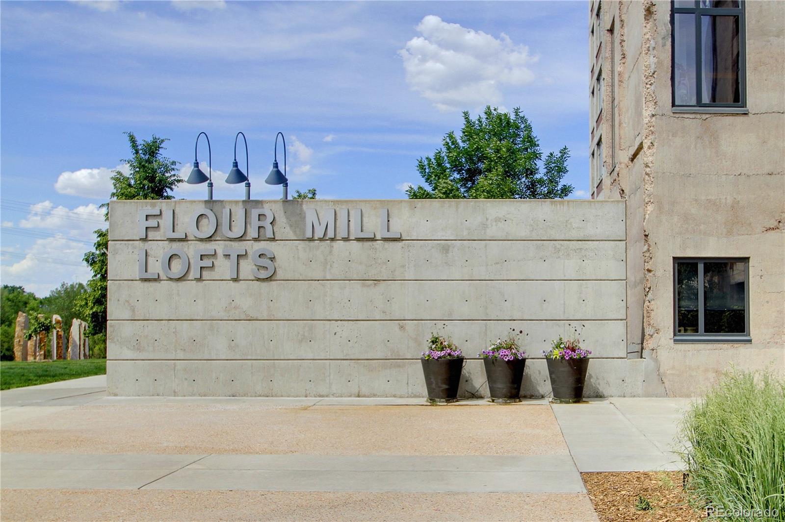2000 Little Raven Street, Unit 102 Denver, CO 80202 - Photo 27 of 36 a view of a sign board with potted plants in front of door