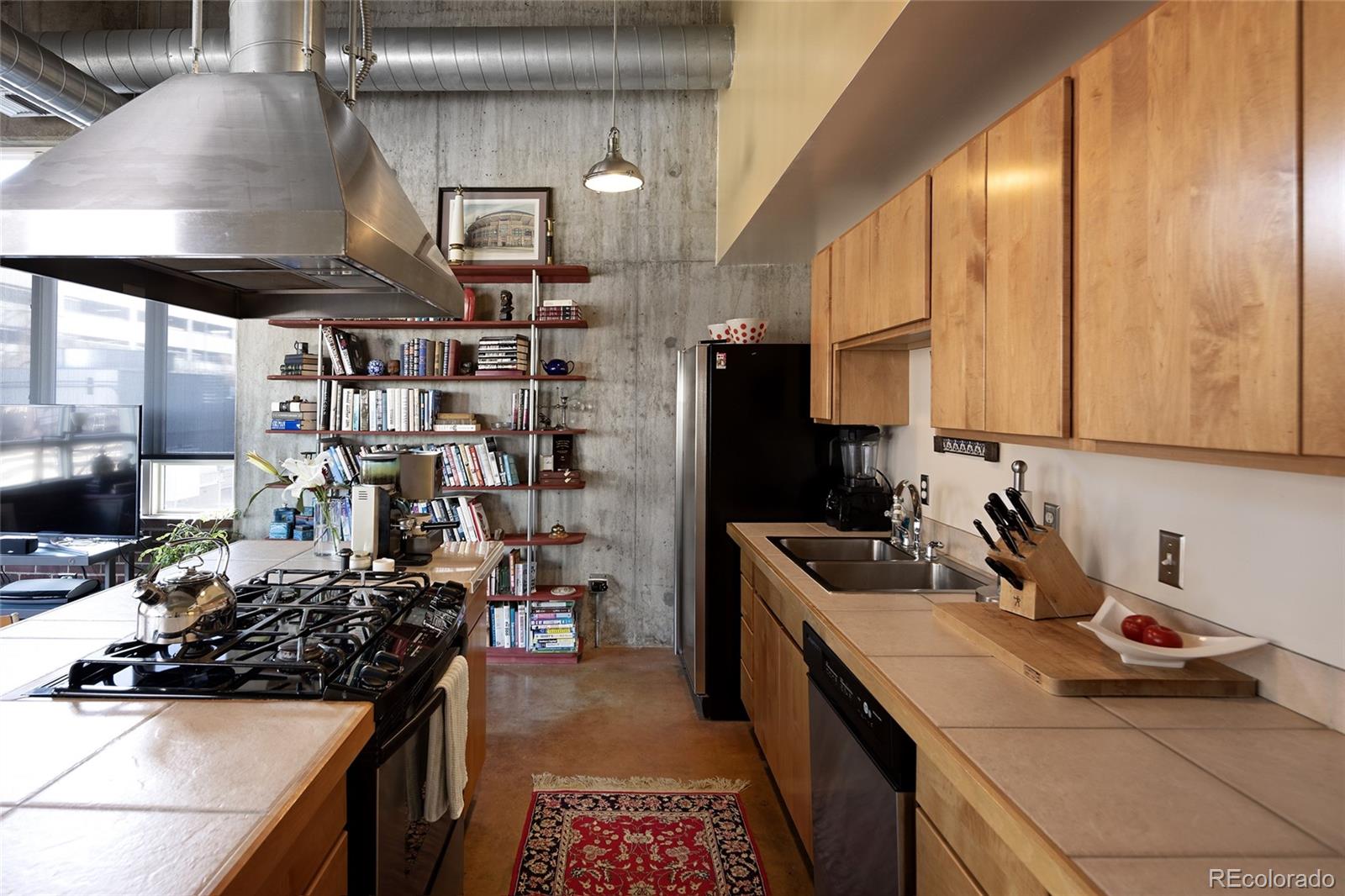 2000 Little Raven Street, Unit 102 Denver, CO 80202 - Photo 5 of 36 a kitchen with a sink stove and refrigerator
