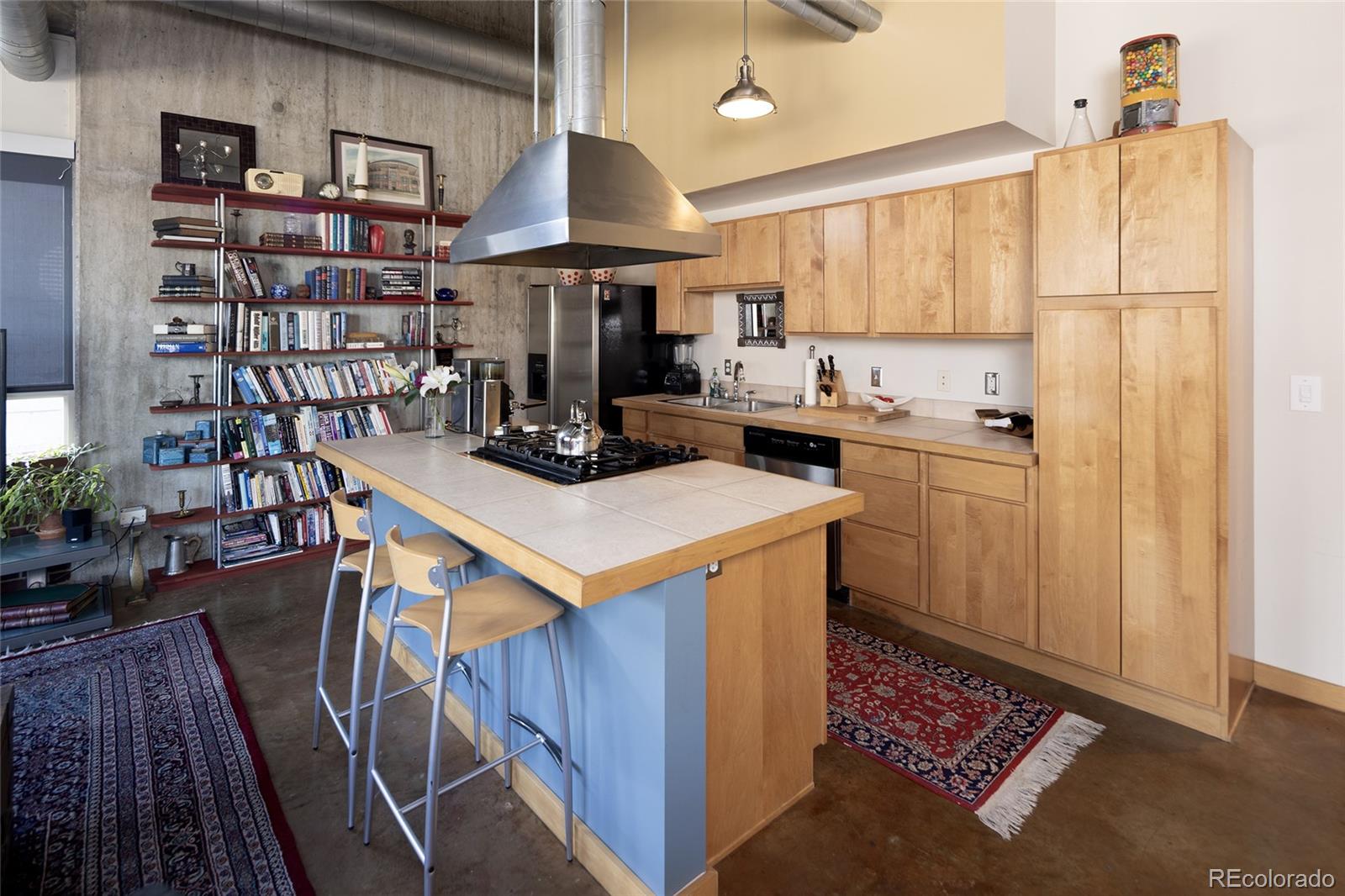 2000 Little Raven Street, Unit 102 Denver, CO 80202 - Photo 7 of 36 a kitchen that has a lot of cabinets in it and wooden floors
