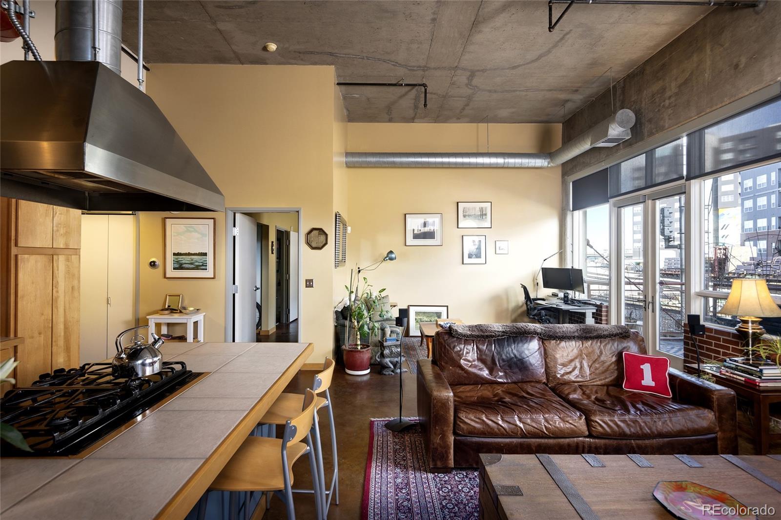 2000 Little Raven Street, Unit 102 Denver, CO 80202 - Photo 9 of 36 a living room with furniture and a large window