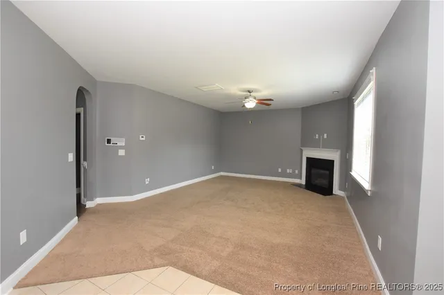wooden floor in an empty room with a fireplace