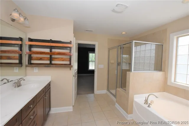 a bathroom with a tub sink and mirror