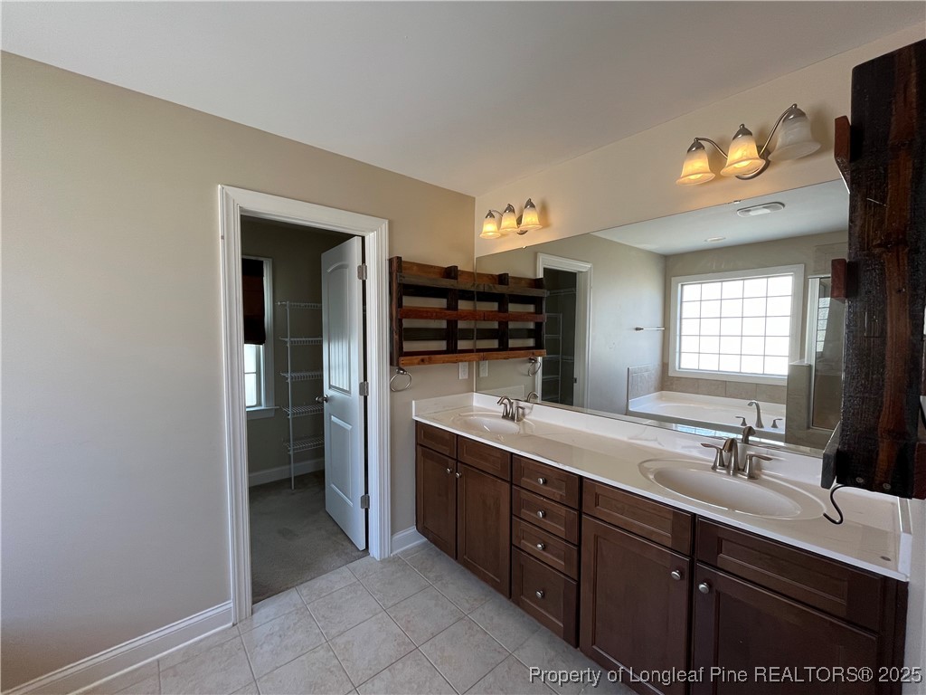 94 Revolutionary Road Cameron, NC 28326 - Photo 16 of 31 a spacious bathroom with a double vanity sink and a mirror