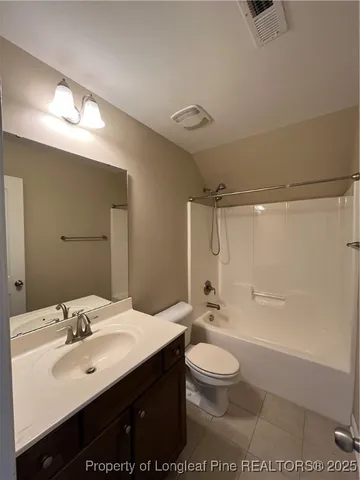 a bathroom with a sink a toilet a mirror and shower