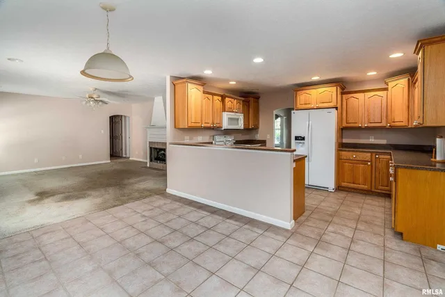 a kitchen with stainless steel appliances granite countertop a stove a sink a refrigerator and cabinets