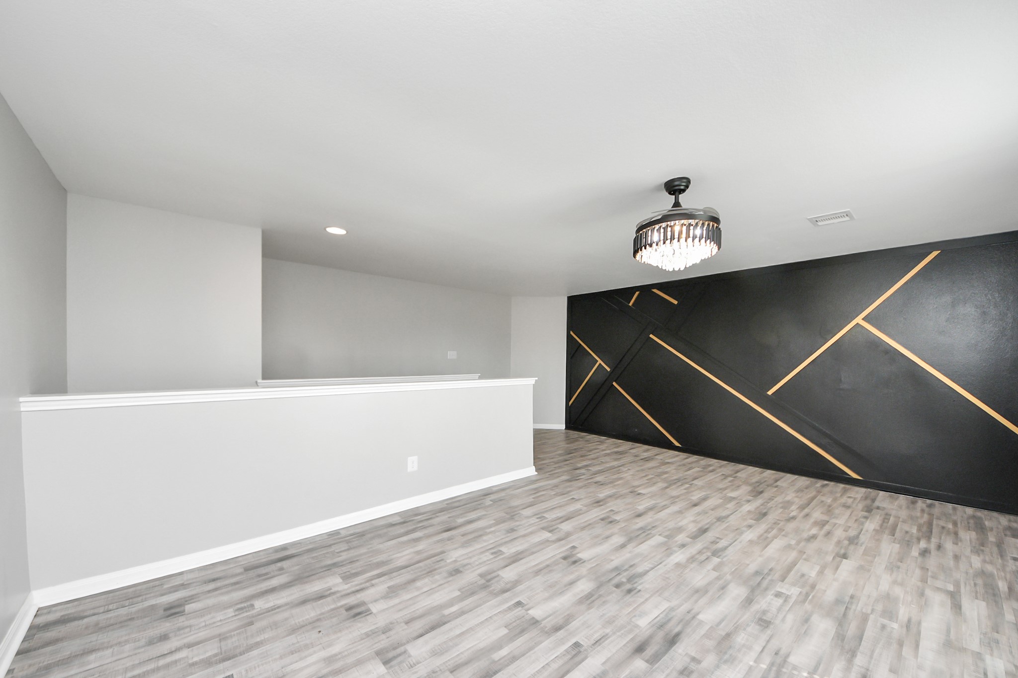 6931 Primrose Road Baytown, TX 77521 - Photo 32 of 50 a room with wooden floor and ceiling fan