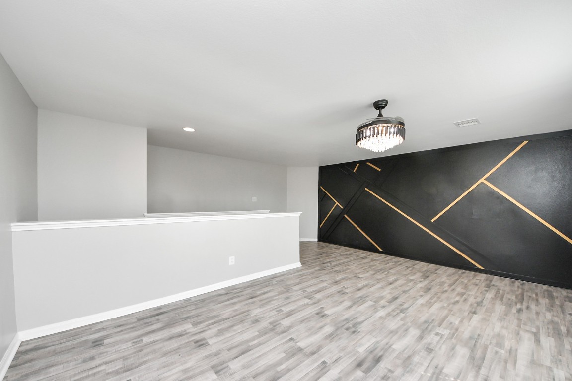6931 Primrose Road Baytown, TX 77521 - Photo 32 of 50 a room with wooden floor and ceiling fan