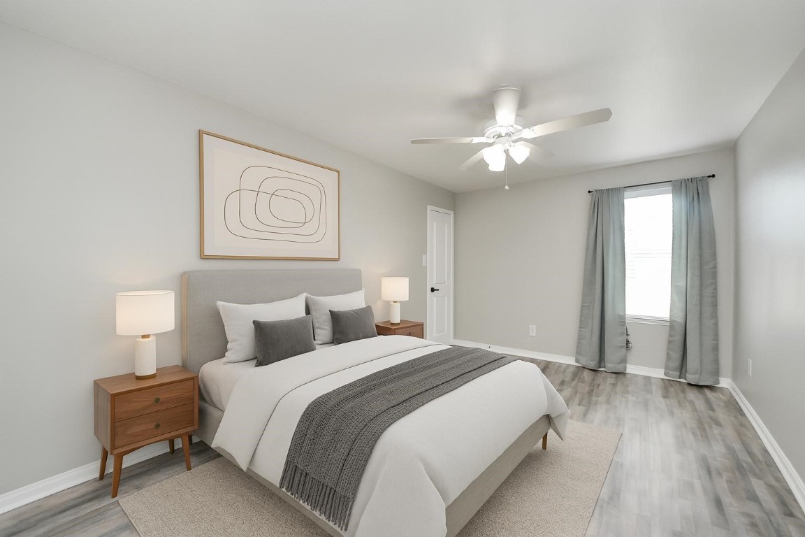6931 Primrose Road Baytown, TX 77521 - Photo 39 of 50 a bedroom with a bed and a chandelier