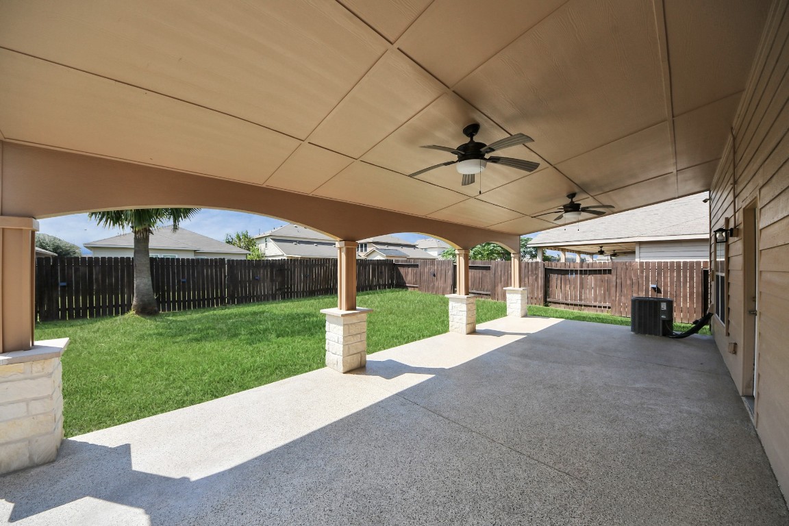 6931 Primrose Road Baytown, TX 77521 - Photo 44 of 50 Expansive covered patio with dual ceiling fans, perfect for outdoor entertaining and relaxation.
