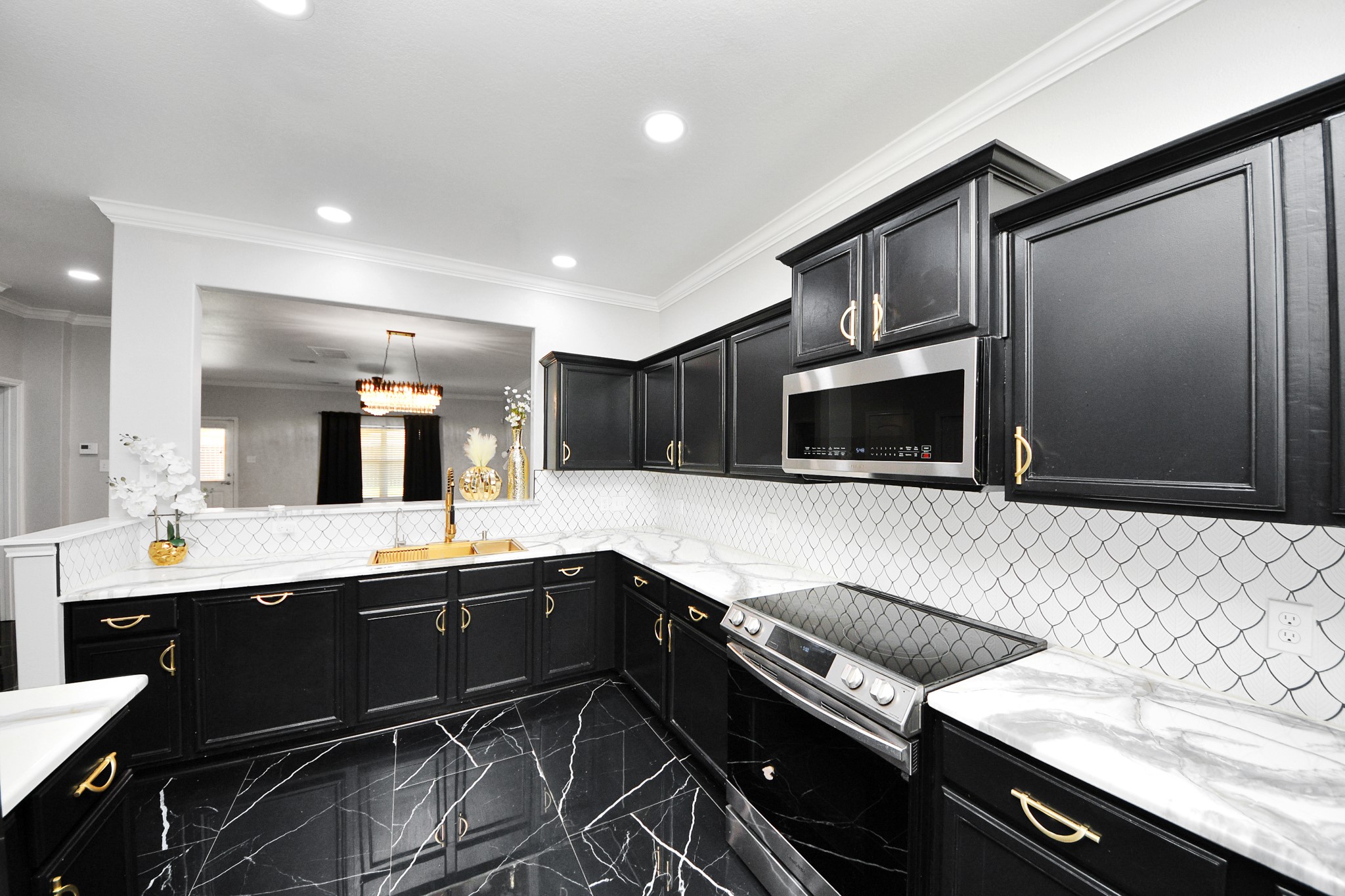 6931 Primrose Road Baytown, TX 77521 - Photo 10 of 50 a kitchen with a sink and stainless steel appliances