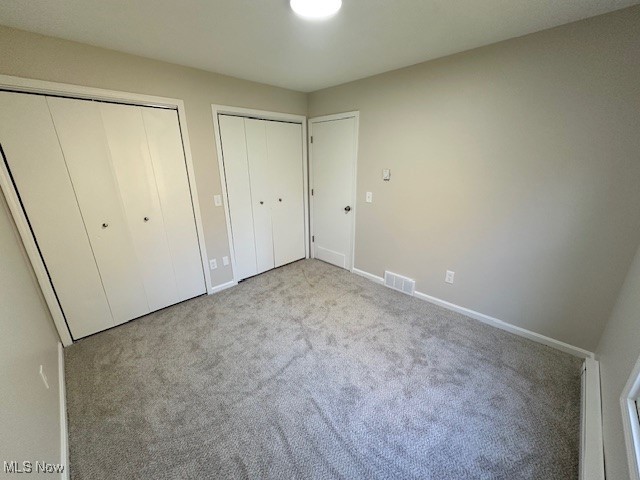 5841 Neff Road Valley City, OH 44280 - Photo 22 of 24 Unfurnished bedroom featuring light colored carpet and two closets