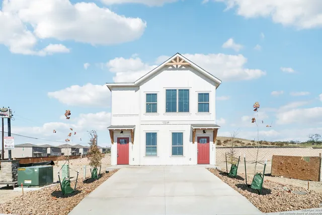 a front view of a house with many windows