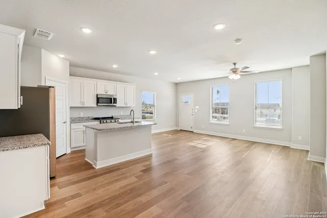 a kitchen with stainless steel appliances a refrigerator sink and cabinets
