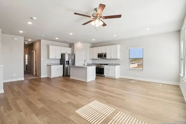 a view of kitchen with sink microwave and refrigerator