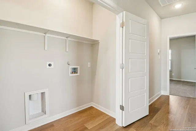 a view of hallway with wooden floor