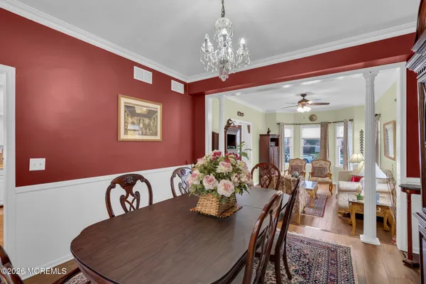 a view of a dining room with furniture wooden floor and chandelier