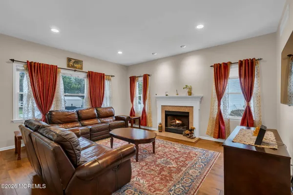 a living room with furniture a fireplace and a window