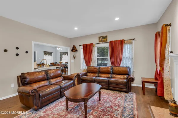 a living room with furniture ceiling fan and a rug