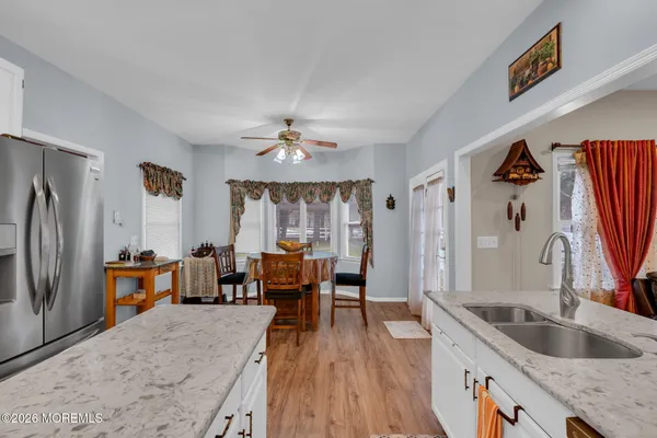 a dining room with furniture a chandelier and window