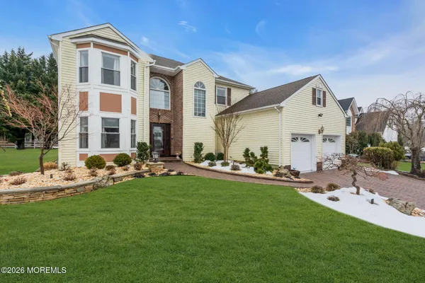 a front view of house with yard and green space