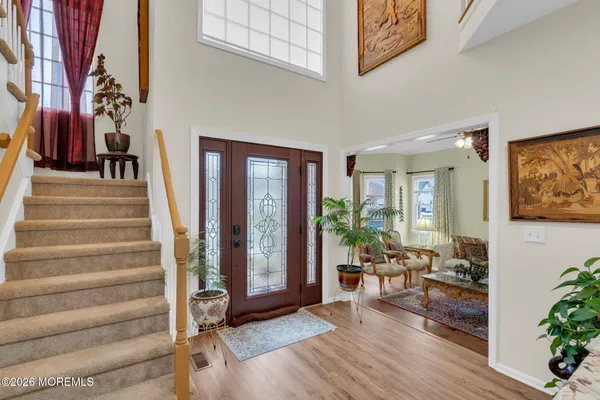 a view of an entryway with wooden floor and windows