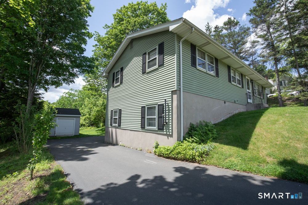 64 Somer Drive Meriden, CT 06451 - Photo 2 of 28 a front view of a house with a yard and trees