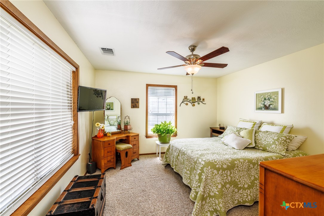 2110 Immenhauser Road Yoakum, TX 77995 - Photo 17 of 39 a bedroom with a bed and wooden floor