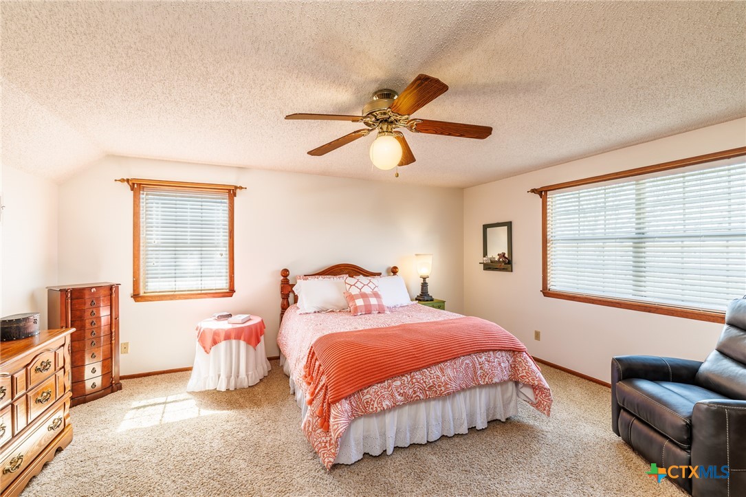 2110 Immenhauser Road Yoakum, TX 77995 - Photo 22 of 39 a bedroom with bed couch and window