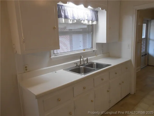a kitchen with sink cabinets and window