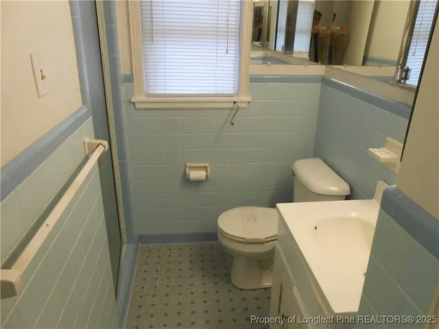 a white toilet sitting next to a bathroom sink