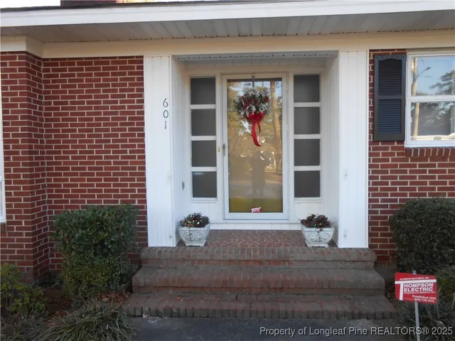 a view of a brick house with potted plants
