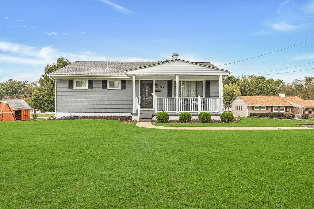 a front view of a house with a garden