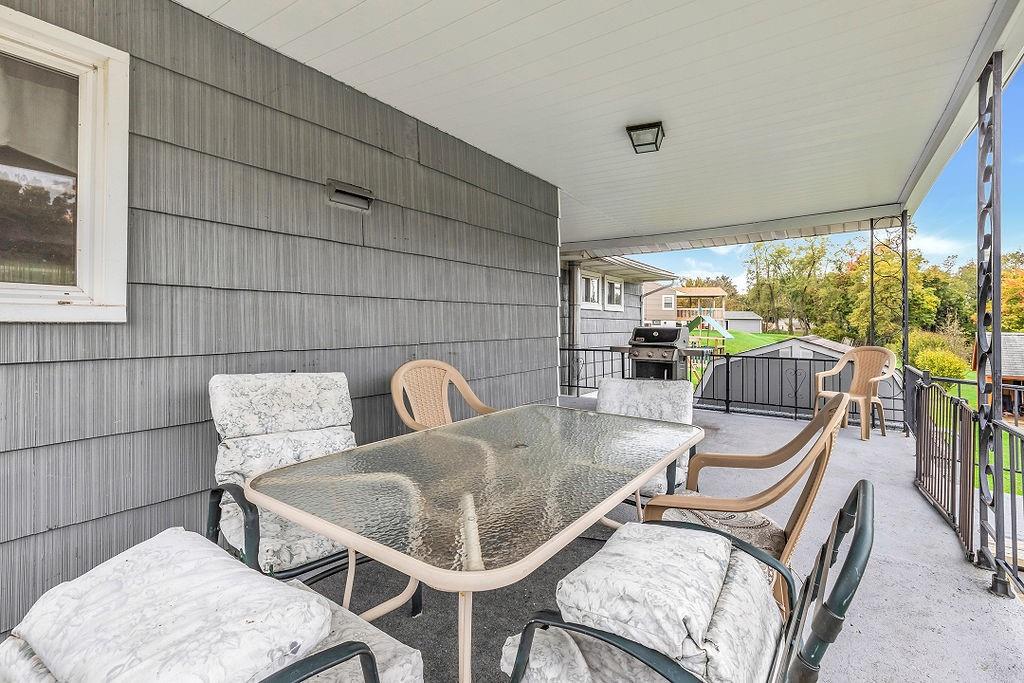 110 Maple Drive Beaver, PA 15009 - Photo 17 of 23 a table and chairs in a balcony